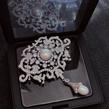 Load image into Gallery viewer, Royal Art Deco Brooch with Vintage Elegance – Silver-White Simulated Pearl Center Stone and Pearl Pendant
